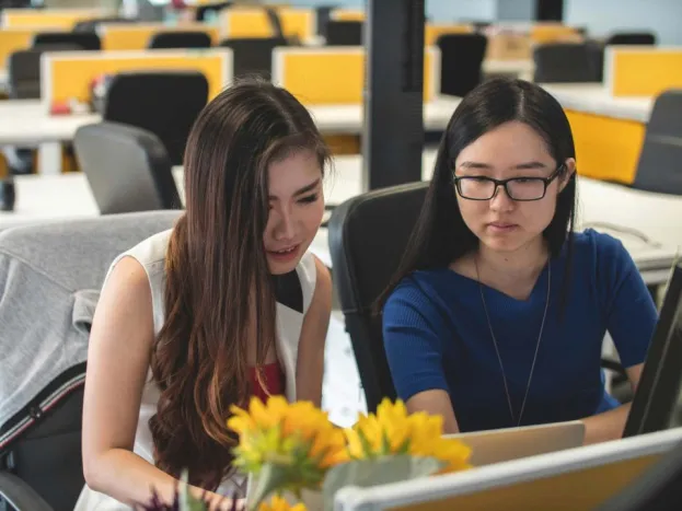 two_women_looking_at_laptop