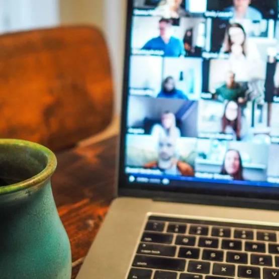 A laptop screen showing participants in a meeting