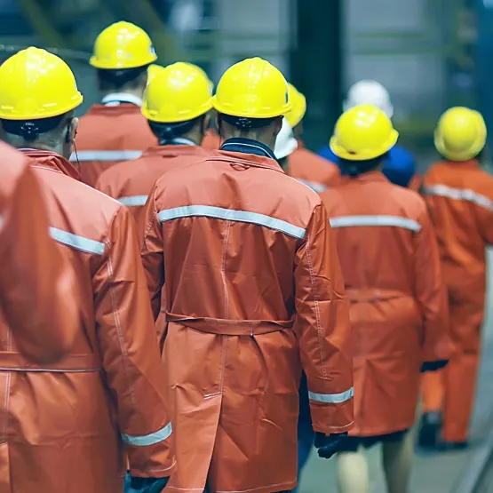 group_of_factory_workers_safety_helmets_cropped