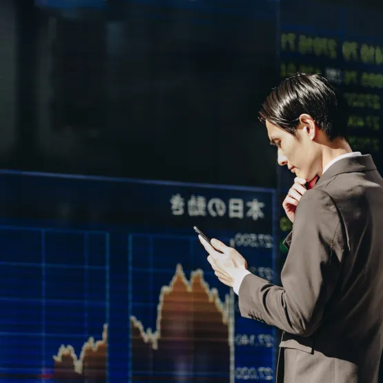 man-checks-stockmarket-stocks-phone-asia