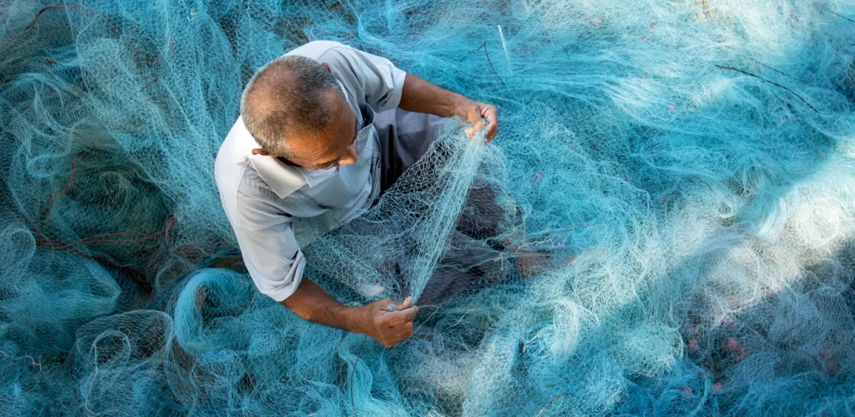 man-fishing-net-blue